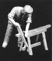 Carpenter sawing on a trestle-horse
