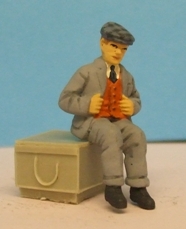 Omen - Seated man wearing a cap