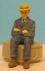 Omen - Seated man, arms folded, wearing a boater hat