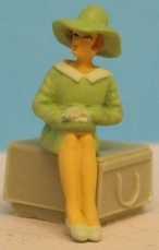 Omen - Seated woman wearing a wide-brimmed hat