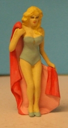 Omen - Girl in one piece swim-suit, holding a towel behind her back